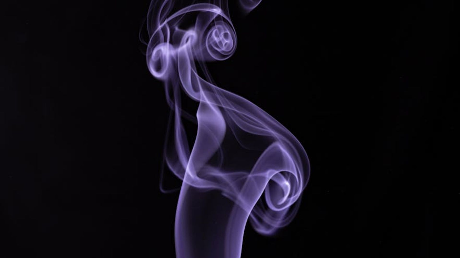 Abstract dark purple background with subtle light patterns.